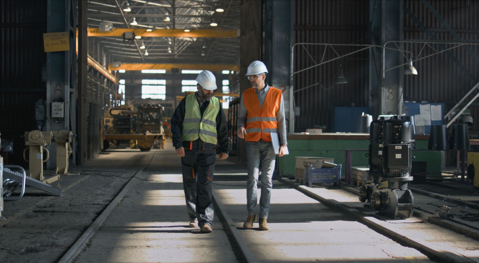 An inspector and a worker in a workshop